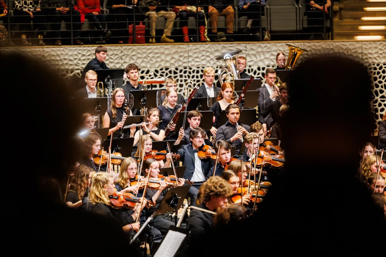 Youth orchestra performing in concert hall