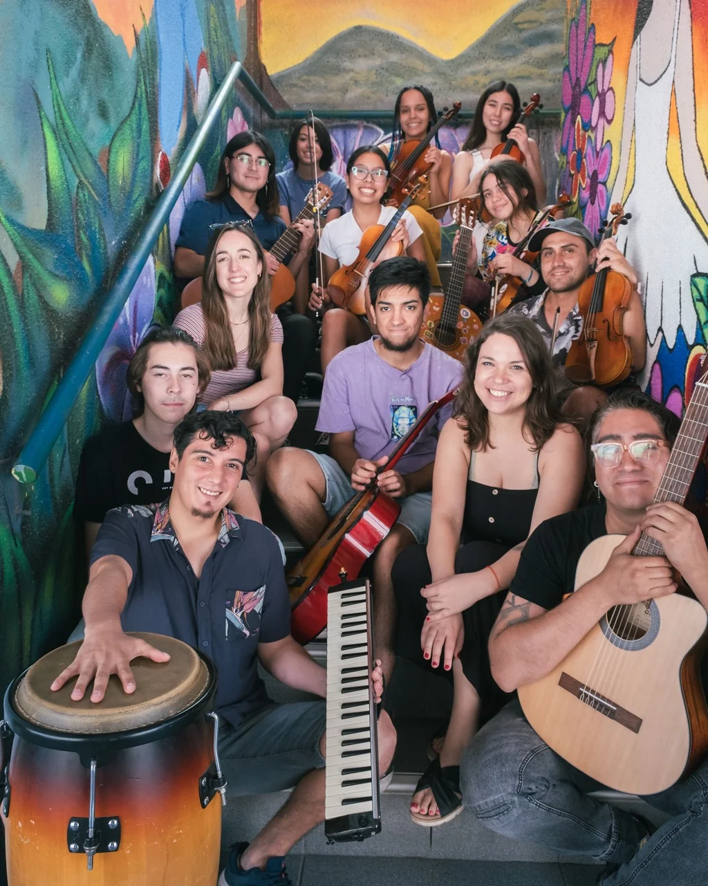 Young musicians gathered on a mural staircase